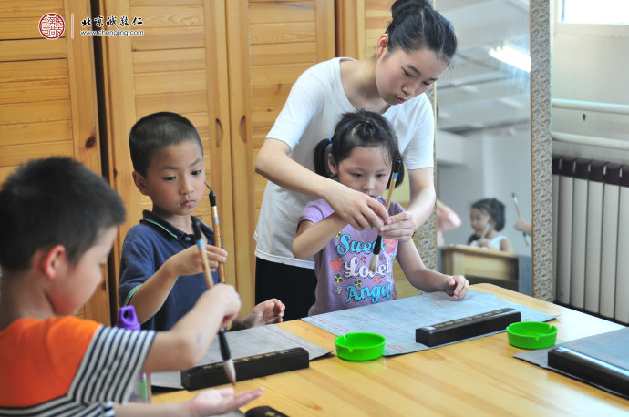 
生活老师指导小学员学习洗衣服